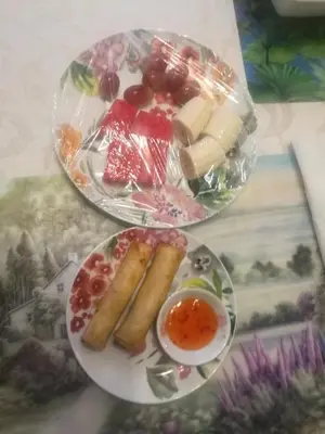 two plates of food and a bowl of dipping sauce at Ambassador B&B Guest Home in Stratford