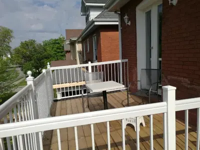 a wooden deck with a bench on a house at Ambassador B&B Guest Home in Stratford