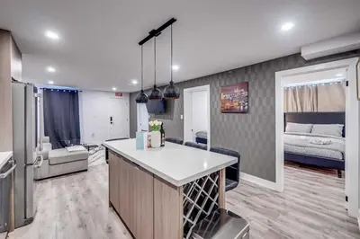 a kitchen and a living room with a bed at Niagara 3 Bed Unit Near the Falls in Niagara Falls