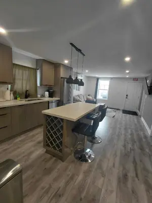 a large kitchen with a table and chairs in it at Niagara 3 Bed Unit Near the Falls in Niagara Falls