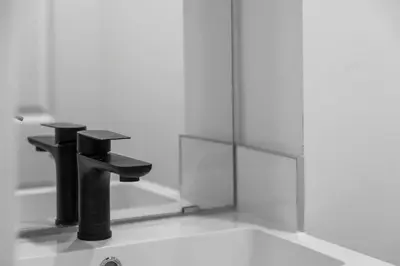a bathroom with a black sink and a mirror at High Park Oasis Modern 1B1B, Kitchen, Laundry in Toronto