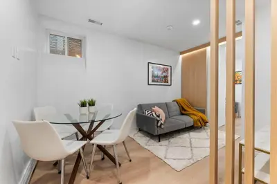 a living room with a glass table and a couch at High Park Oasis Modern 1B1B, Kitchen, Laundry in Toronto