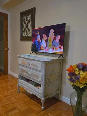a flat screen tv on top of a dresser at Homely Inn in Toronto