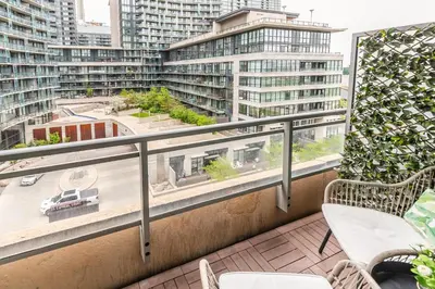 a balcony with a view of tall buildings at RivetStays - Dan Leckie Suite in Toronto