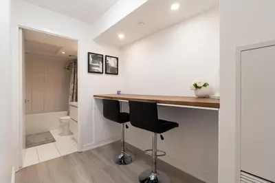 a bathroom with a counter and a toilet in a room at RivetStays - Dan Leckie Suite in Toronto