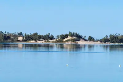 an island in the middle of a lake at Sandbanks Beach Cottage in West Lake