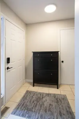 a room with a black dresser and a door at Spacious & Cozy in the Heart of Town in London