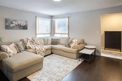 a living room with a couch and a tv at Spacious & Cozy in the Heart of Town in London