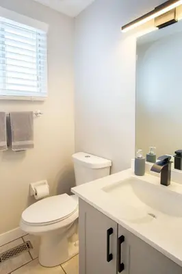 a white bathroom with a toilet and a sink at Spacious & Cozy in the Heart of Town in London
