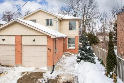 a house with a garage in the snow at Spacious & Cozy in the Heart of Town in London