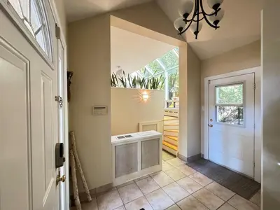 a hallway with a white door and a window at Spacious 4-Bedrooms Friendly House Toronto-Parking in Markham