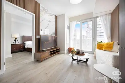a living room with a tv and a large window at KK Hotel in Markham