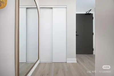an empty room with a mirror and a door at KK Hotel in Markham