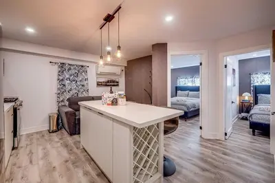 a kitchen and living room with a couch and a table at Modern 2 Bed Unit Near the Falls in Niagara Falls
