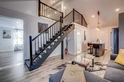 a living room with a staircase in a house at Niagara Falls 2BR Unit in Niagara Falls