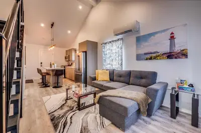 a living room with a couch and a table at Niagara Falls 2BR Unit in Niagara Falls