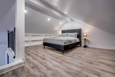 a bedroom with a bed and a tv in it at Niagara Falls 2BR Unit in Niagara Falls