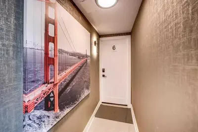 a hallway with a painting of the golden gate bridge at Modern 2BR Unit Near the Falls in Niagara Falls