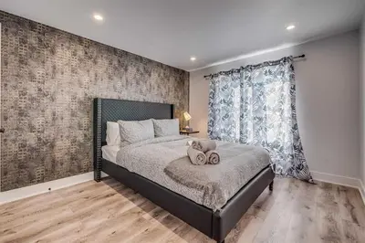 a bedroom with a bed with two towels on it at Modern 2BR Unit Near the Falls in Niagara Falls