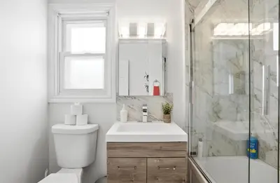 a bathroom with a toilet and a sink and a shower at 5 Bedroom House - 1 Block from the Falls in Niagara Falls