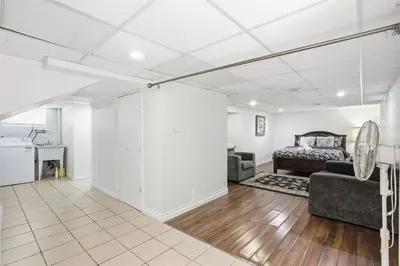 a living room with a bed and a couch at 5 Bedroom House - 1 Block from the Falls in Niagara Falls