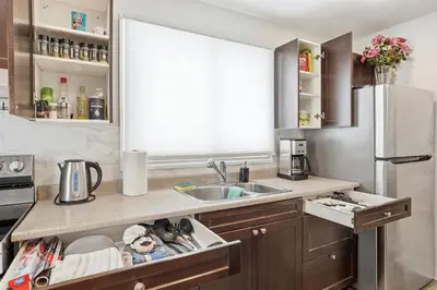 a kitchen with a sink and a refrigerator at 5 Bedroom House - 1 Block from the Falls in Niagara Falls