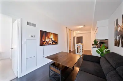 a living room with a couch and a table at Skyline Stays Chic 2BR Steps from Everything in Toronto