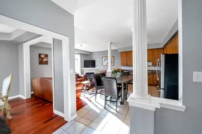 a kitchen and living room with a table and chairs at Thrilling Homey Escape In Toronto Area in Ajax