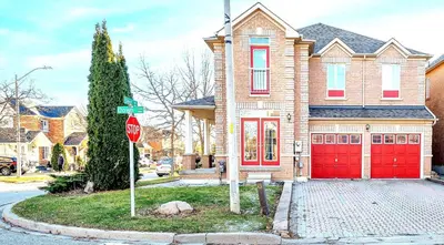 a stop sign in front of a house with red garage at Thrilling Homey Escape In Toronto Area in Ajax
