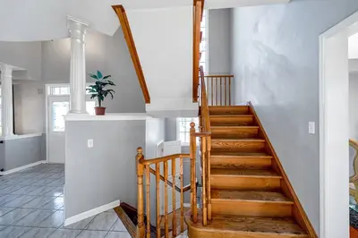 a staircase in a home with white walls at Thrilling Homey Escape In Toronto Area in Ajax