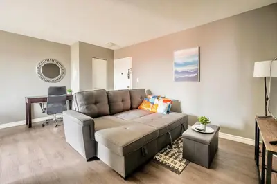 a living room with a couch and a table at Charming Newly Renovated Condo - Glenview West in Hamilton