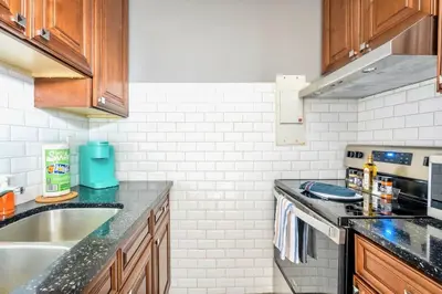 a kitchen with a sink and a stove at Charming Newly Renovated Condo - Glenview West in Hamilton