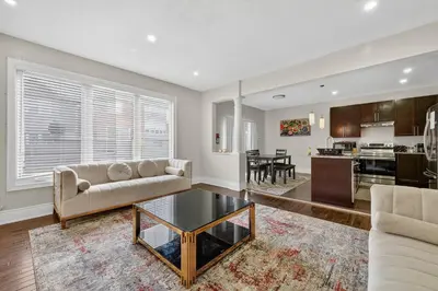 a living room with a couch and a table at Spacious Modern 5BR Home Sleeps 13 Family home in Milton