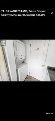 a kitchen with a white refrigerator and a microwave at East Lake Cottages in Cherry Valley