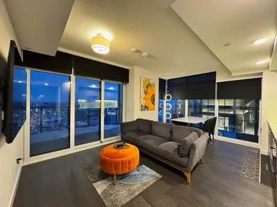 a living room with a couch and a table at Luxury 76 floor 2B2B Downtown Toronto Skyline View in Toronto