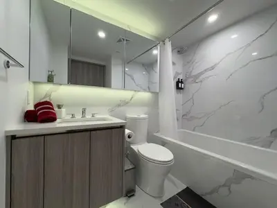 a bathroom with a toilet and a sink and a tub at Luxury 76 floor 2B2B Downtown Toronto Skyline View in Toronto
