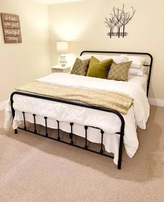 a bedroom with a bed with white and green pillows at Charming private Guest Suite near Thermea Spa in Whitby