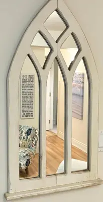 an arch mirror with a chair in a room at Charming private Guest Suite near Thermea Spa in Whitby