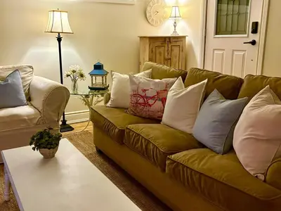 a living room with a couch and a table at Charming private Guest Suite near Thermea Spa in Whitby