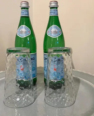 two glass bottles sitting on top of a table at Charming private Guest Suite near Thermea Spa in Whitby