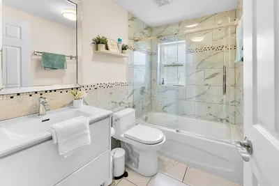 a bathroom with a toilet and a sink and a shower at Cozy Family Retreat Minutes From the Falls and Pet Friendly in Niagara Falls