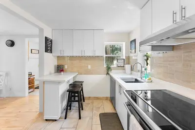 a kitchen with white cabinets and a counter top at Cozy Family Retreat Minutes From the Falls and Pet Friendly in Niagara Falls