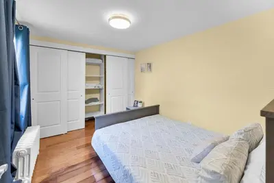 a bedroom with a bed and a closet at Cozy Family Retreat Minutes From the Falls and Pet Friendly in Niagara Falls