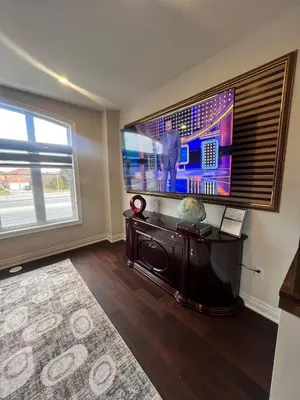 a living room with a large flat screen tv at Modern Luxury Townhome with 2BR Balcony plus Parking - Happy Oaks in Oakville