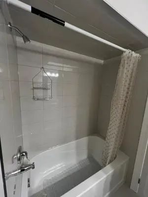 a bathroom with a bath tub with a shower at Modern Luxury Townhome with 2BR Balcony plus Parking - Happy Oaks in Oakville