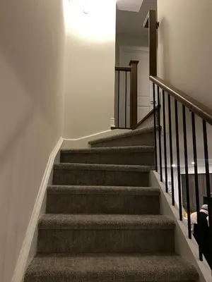 a stairway with a stair case with a light at Modern Luxury Townhome with 2BR Balcony plus Parking - Happy Oaks in Oakville