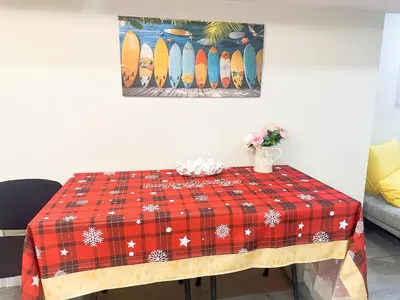 a table with a red blanket on it with surfboards on it at Newly Renovated and Spacious 3BR Private Apartment with 3 Baths & Parking in Richmond Hill