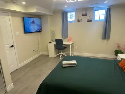 a bedroom with a bed and a desk and a television at Newly Renovated and Spacious 3BR Private Apartment with 3 Baths & Parking in Richmond Hill