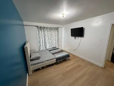 a bedroom with a bed and a flat screen tv at Private Room Near Airport D12 in Mississauga