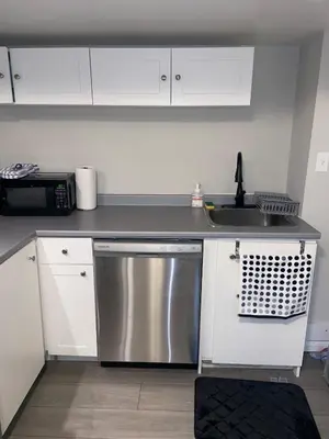 a kitchen with a sink and a stainless steel dishwasher at ClassicPavillion INN in Bowmanville